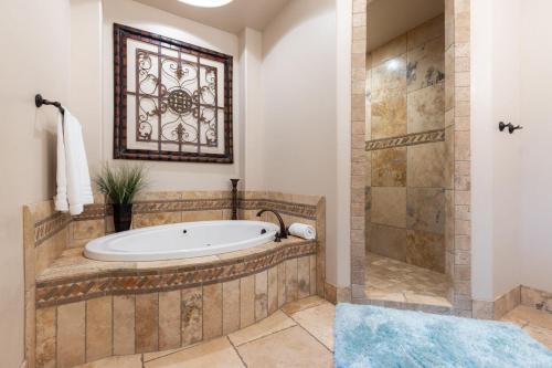 a bathroom with a tub and a shower at D5-Coral Springs Poolside-Ground Floor 3-bedroom Hillside View in Hurricane