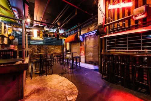 a bar with chairs and tables in a room at The Lansdowne Hotel in Sydney