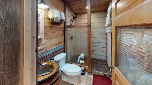 a small bathroom with a toilet and a sink at Line Shack On Tenderfoot Trail With High Speed Wifi in Red River
