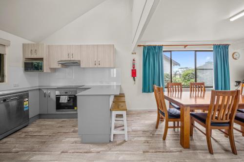 a kitchen and dining room with a table and chairs at Haven Holiday Resort Sussex Inlet in Sussex inlet