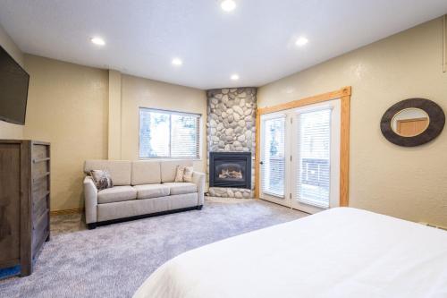 a bedroom with a bed and a couch and a fireplace at Majestic Suite 5 Bedroom Brighton Chalet in Brighton