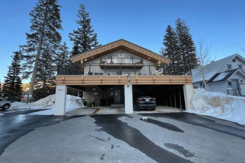 a house with a car parked in a parking lot at Majestic Suite 5 Bedroom Brighton Chalet in Brighton