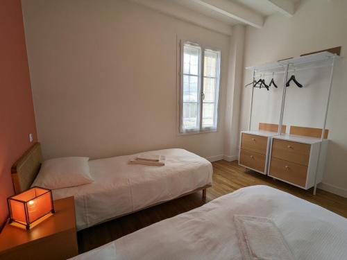 a bedroom with two beds and a table and a window at Gîte Vars, 4 pièces, 6 personnes - FR-1-653-16 in Vars