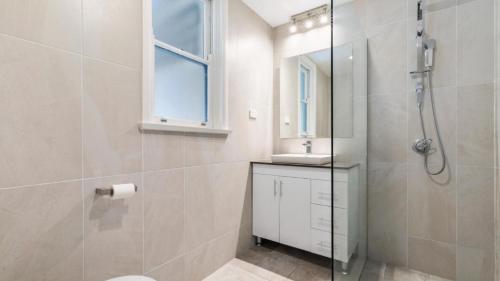 a bathroom with a shower and a toilet and a sink at Beach Heaven in Hawks Nest