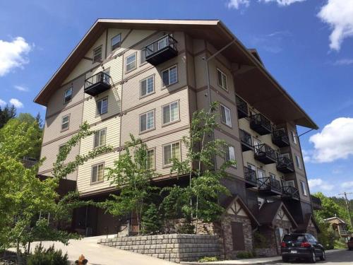 a large building with balconies on the side of it at Penthouse Studio w Mtn Sunrise Views & Near Silver Mtn in Kellogg