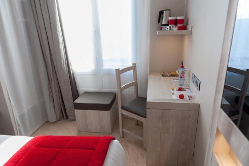 a bedroom with a desk with a chair and a bed at Hôtel le 209 Paris Bercy in Paris