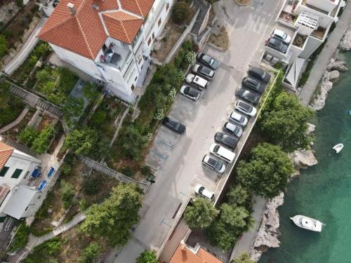 an aerial view of cars parked next to the water at Apartment Beautifull View in Rabac