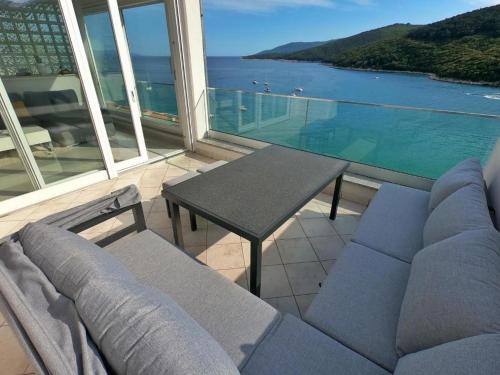 a living room with a couch and a table at Apartment Beautifull View in Rabac
