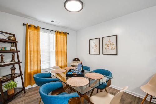a dining room with blue chairs and a table at DTGem-SelfCheckin-RainShower-300M-Parking-Walkable in Raleigh