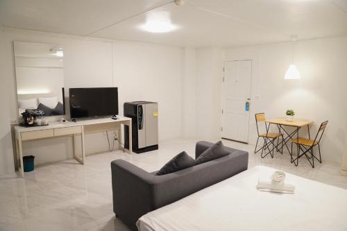 a living room with a couch and a table at View Place Hotel & Residence in Bangkok