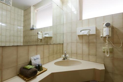 a bathroom with a sink and a mirror at Hospitality Port Hedland in Port Hedland