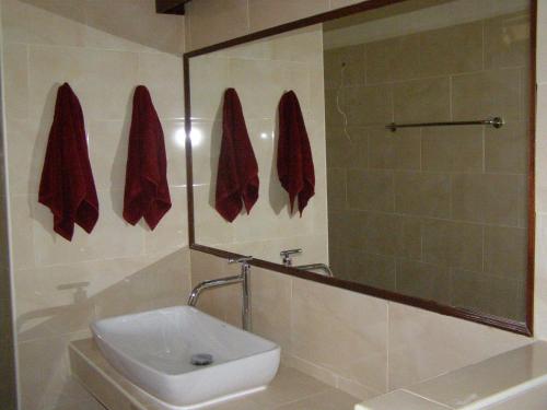 a bathroom with a sink and a toilet and a mirror at Lucky Gecko Garden in Ko Chang