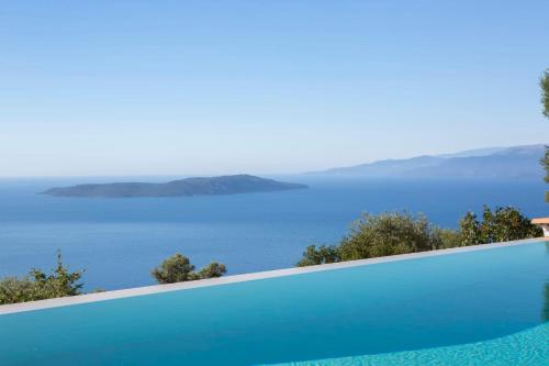 a swimming pool with a view of the ocean at Villa Evalin - Pretty Villa Like at Home for Unforgettable Holidays in Sivota