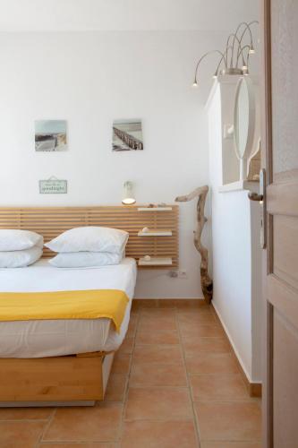 a bedroom with a bed with yellow and white sheets at Villa Evalin - Pretty Villa Like at Home for Unforgettable Holidays in Sivota