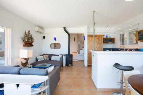 a living room with a couch and a table at Villa Evalin - Pretty Villa Like at Home for Unforgettable Holidays in Sivota