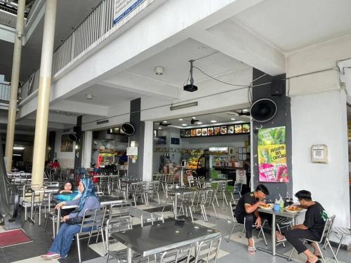 a group of people sitting at tables in a restaurant at 3Element*CornerUnit*Goodview* *NSK*Aeon*wifi in Seri Kembangan