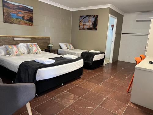a room with two beds in a room with at Spanish Lace Motor Inn in Townsville