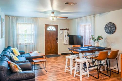 a living room with a blue couch and a table at Vacation House, 2 Miles to Beach, Smart TVs, Grill in Navarre