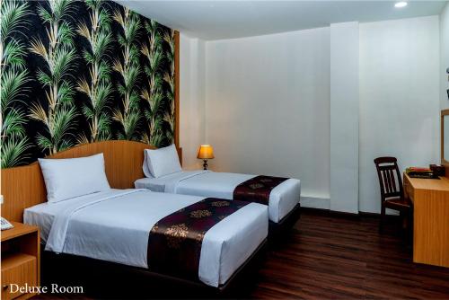 Ένα ή περισσότερα κρεβάτια σε δωμάτιο στο Grand Bayu Hill Hotel