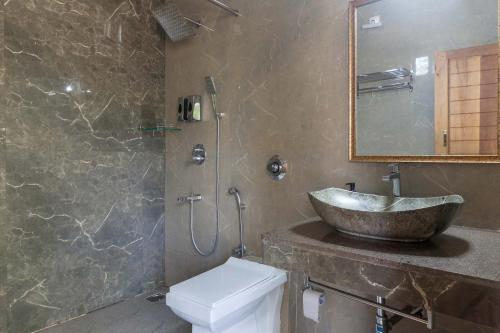 a bathroom with a sink and a toilet at 5BR Coffee & Mist Luxury Villa-High Speed Wifi- Comp Breakfast, Pvt Pool, and Coffee Estate Virajpet in Madikeri