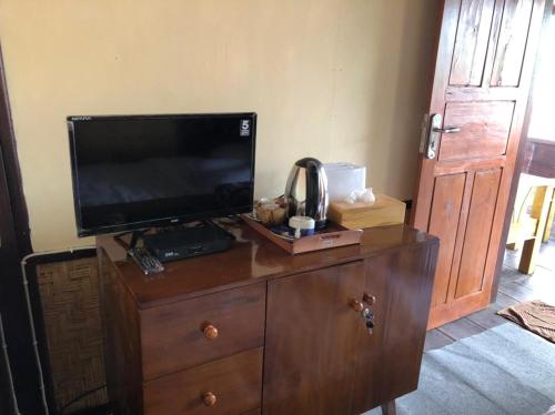 a television on top of a dresser in a room at Pondok Ganesha Bali in Gitgit