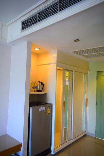 a kitchen with a refrigerator in a room at Seapine Beach Golf and Resort Hua Hin in Hua Hin