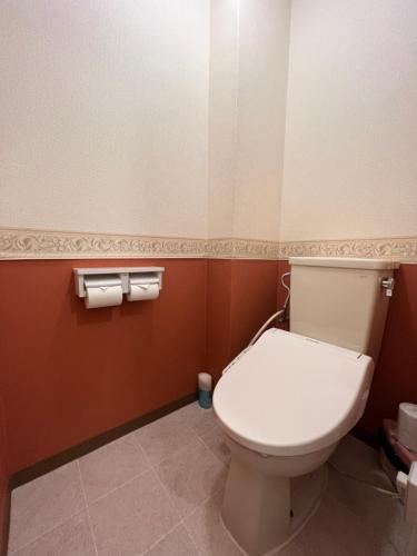 a bathroom with a toilet and two rolls of toilet paper at Ryokan Kousen Kazeya Group in Nara