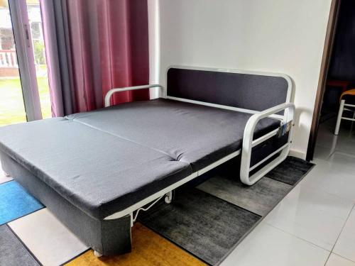 a hospital bed sitting in a room next to a window at Tamu Homestay Terengganu in Kuala Terengganu