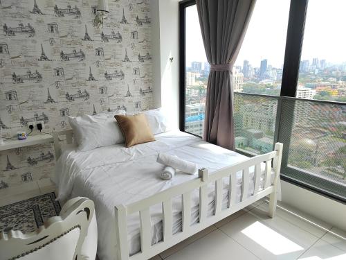 a white bed in a room with a window at Gurney Duplex / 2bedrooms / 8pax in George Town