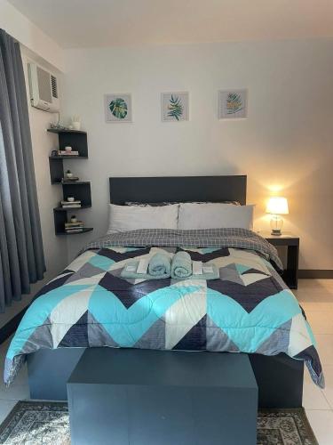 a bedroom with a bed with two people on it at Spacious condominium in Davao City