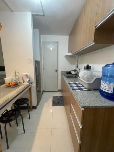 a kitchen with a sink and a counter top at Spacious condominium in Davao City