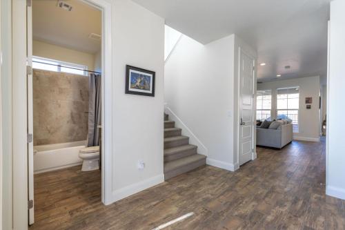 a living room with a staircase and a toilet at The Escondido Gem, Pet Friendly, Pickleball Courts in Washington