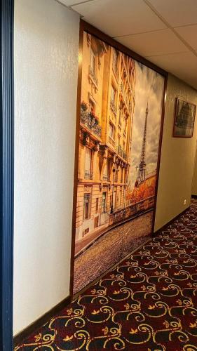 a hallway with a large painting of the eiffel tower at Hotel Le Paris in Noumea