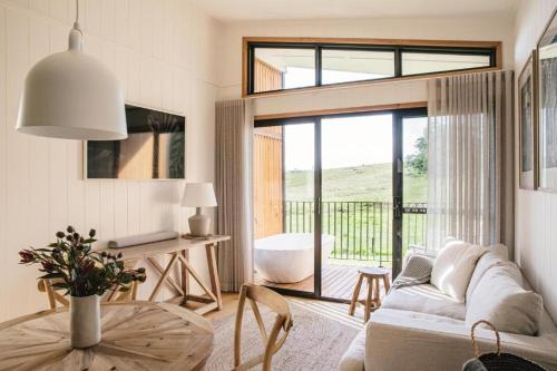 a living room with a couch and a table at Cupitt's Estate Villas in Ulladulla