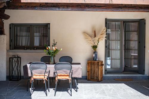 a table and chairs in front of a building at MURANO Place - FILIGRANA House in Murano