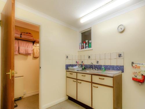 a small bathroom with a sink and a mirror at The Loft in Carbis Bay