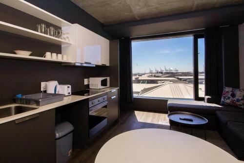 a kitchen with a view of an airport at Gorgeous Studio 534 Wex 1 in Cape Town