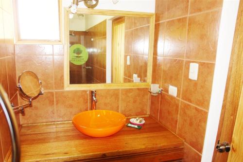a bathroom with a large orange bowl sink at Amazonia Bungalow in Máncora