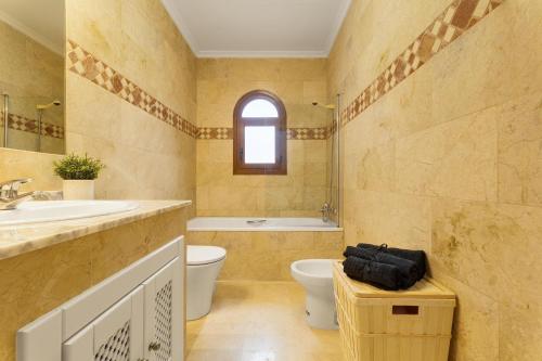 a bathroom with a toilet and a sink and a tub at soleadore sol in Orihuela