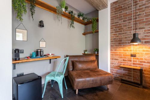 a chair and a leather chair in a room at Old Rooms in Quartu SantʼElena