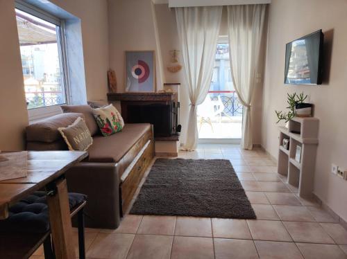 a living room with a couch and a fireplace at Golden Sky 1 Apartment in Perea