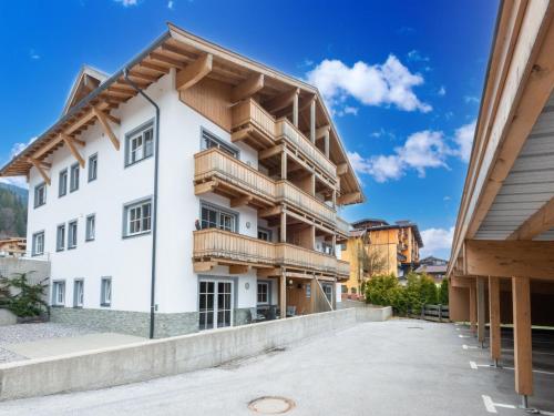a large white building with wooden balconies at Luxury penthouse with Balcony Ski Storage Carport Lift in Brixen im Thale