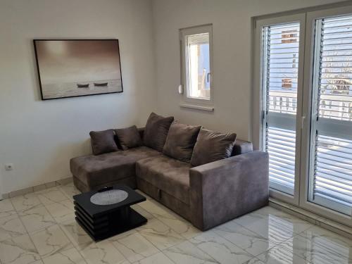 a living room with a brown couch and a table at Villa Maria in Posedarje