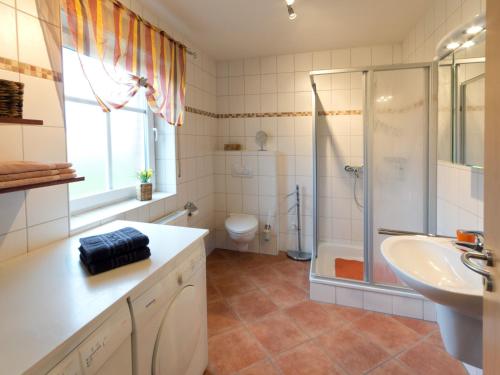 a bathroom with a shower and a sink and a toilet at Ferienhaus Sabine Norddeich in Norddeich