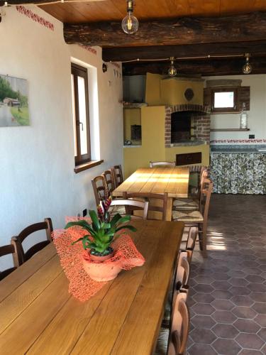a dining room with a wooden table and chairs at Cascina Coste in Roppolo