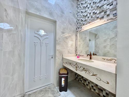 a bathroom with a sink and a mirror at AlDana Resort & Hotels in Barka