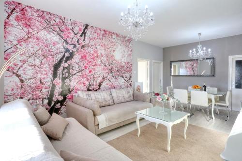 a living room with a large tree mural on the wall at HACIENDA MIA with pool,BBQ,free parking in Zadar