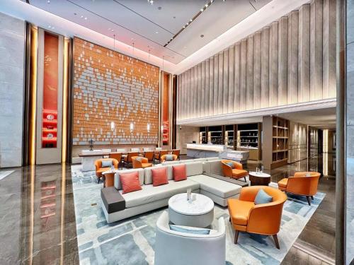 a lobby with a couch and chairs in a building at Landmark International Hotel in Guangzhou