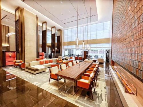 a large dining room with a long table and chairs at Landmark International Hotel in Guangzhou