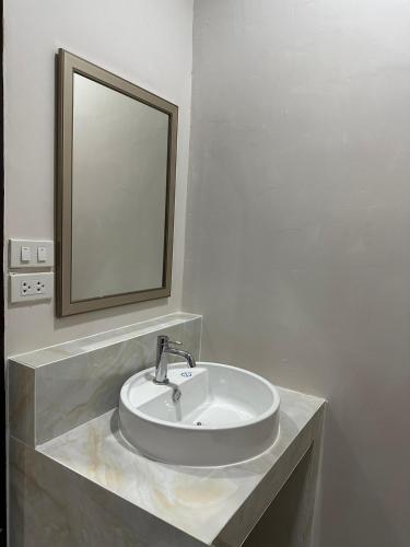 a bathroom sink with a mirror on a counter at CottagePine Rayong Resort&Cafe in Ban Ko Kloi